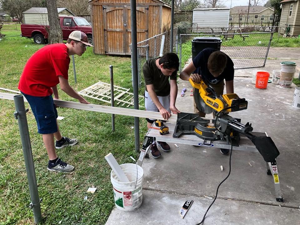 North Shore teenagers operating a miter saw in Houston